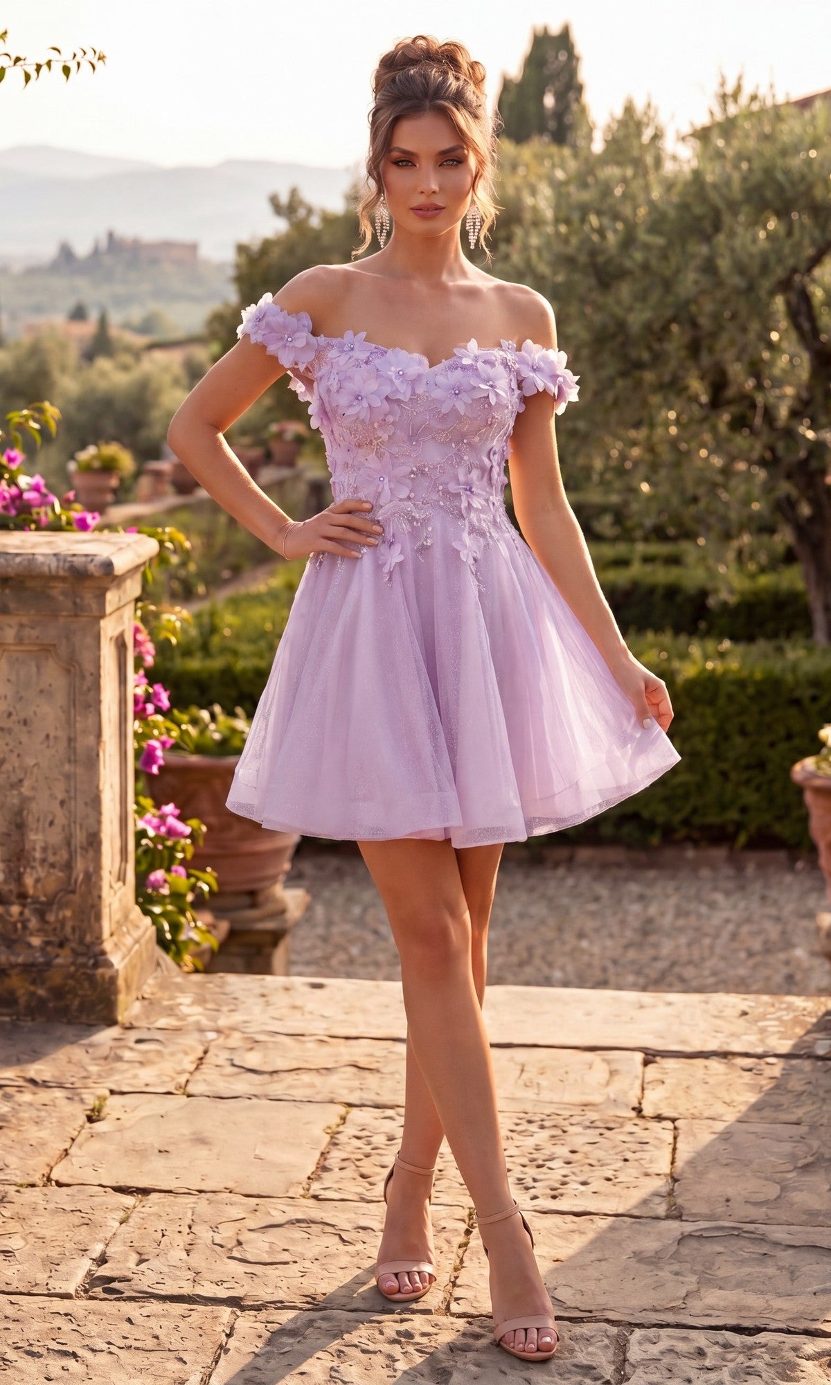 A woman stands on a stone path in a garden, surrounded by greenery and flowers, wearing the Chicas C312 short lilac homecoming dress. The off-shoulder fit-and-flare style features delicate 3D floral appliqués.